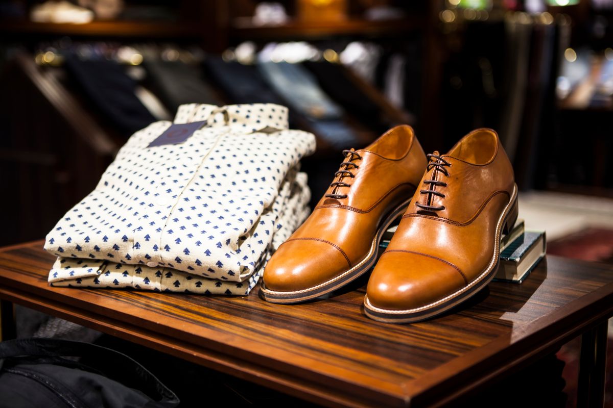 Clothing and leather shoes displayed in a shop
