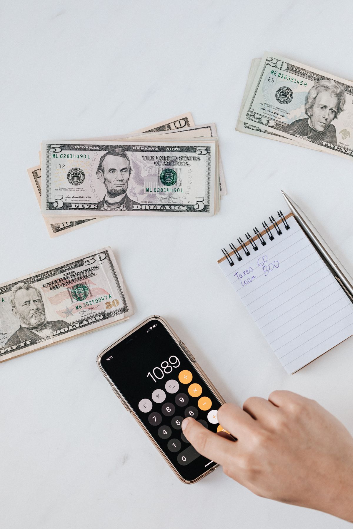 A calculator and paper currency on a table