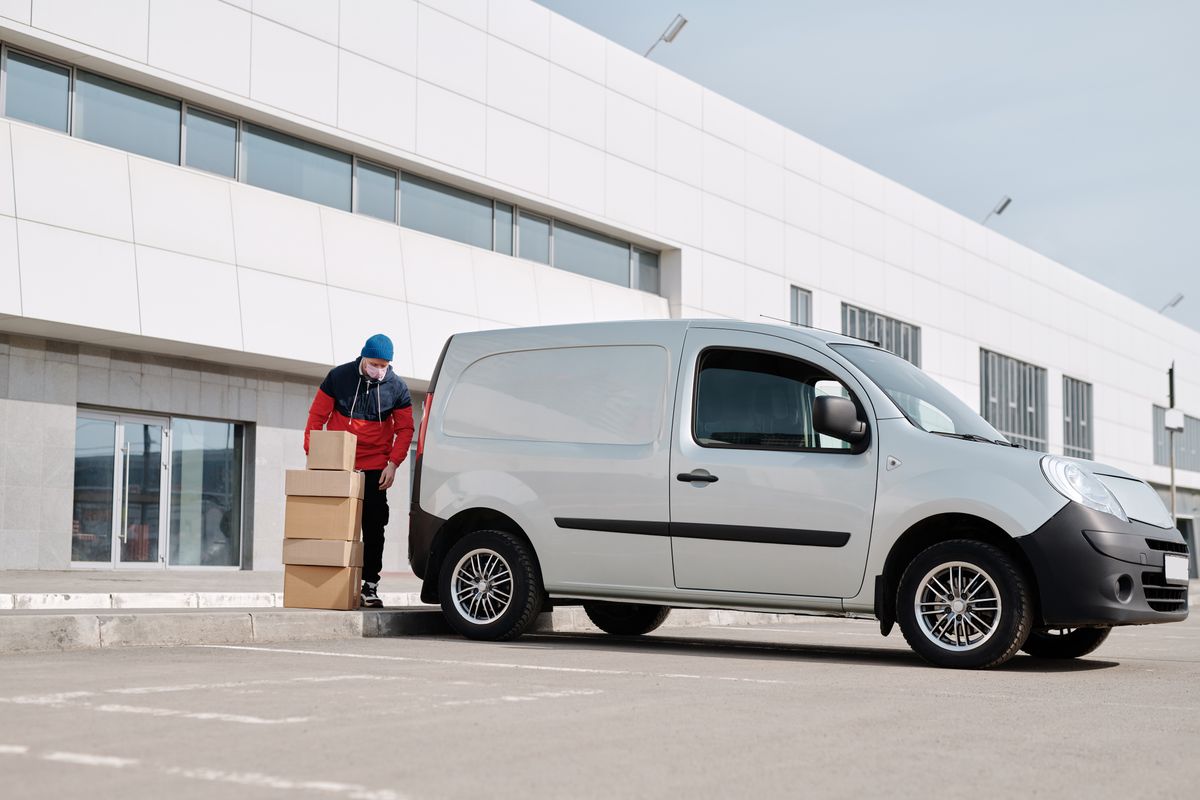 A delivery van outside a commercial building