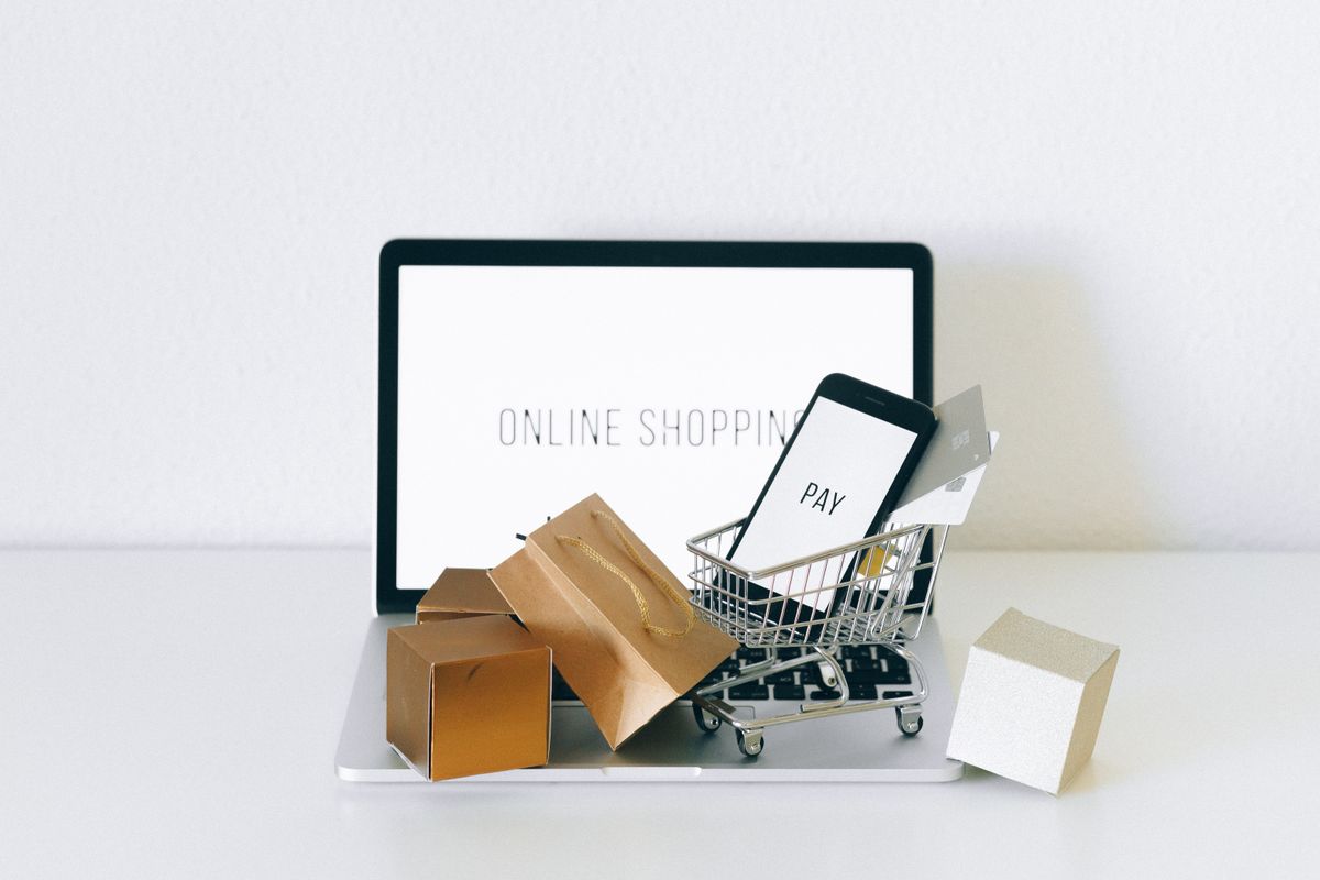 A laptop with miniature shopping bags